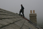 Ridge tiles being put in place Ridge tiles being put in place